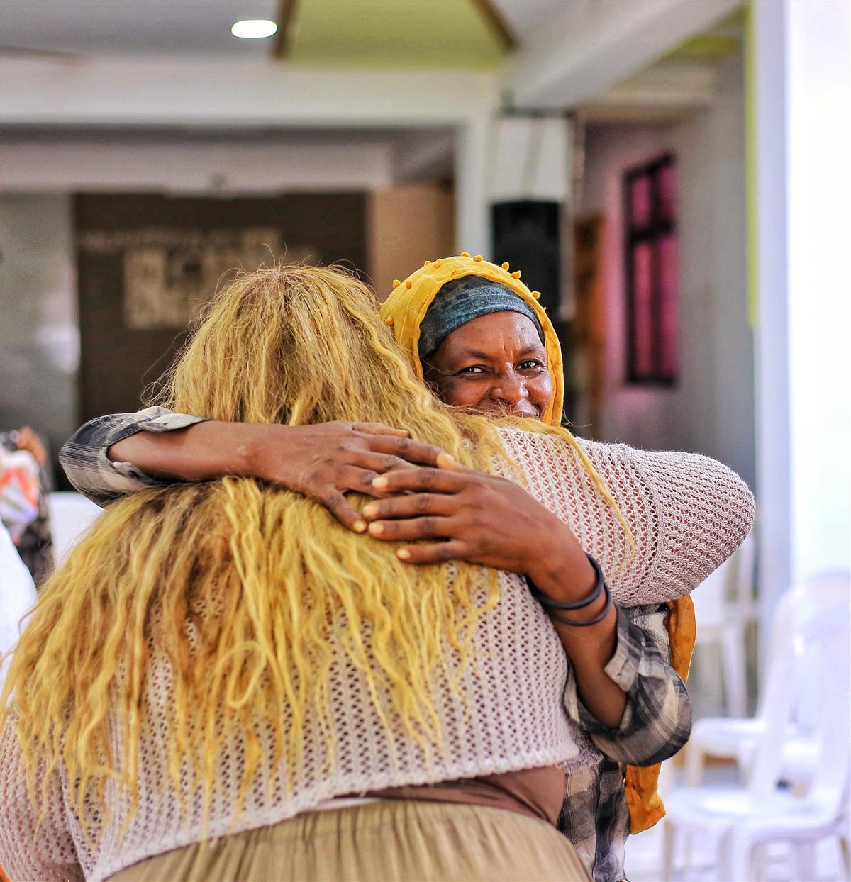 BeLight volunteer embracing a community member
