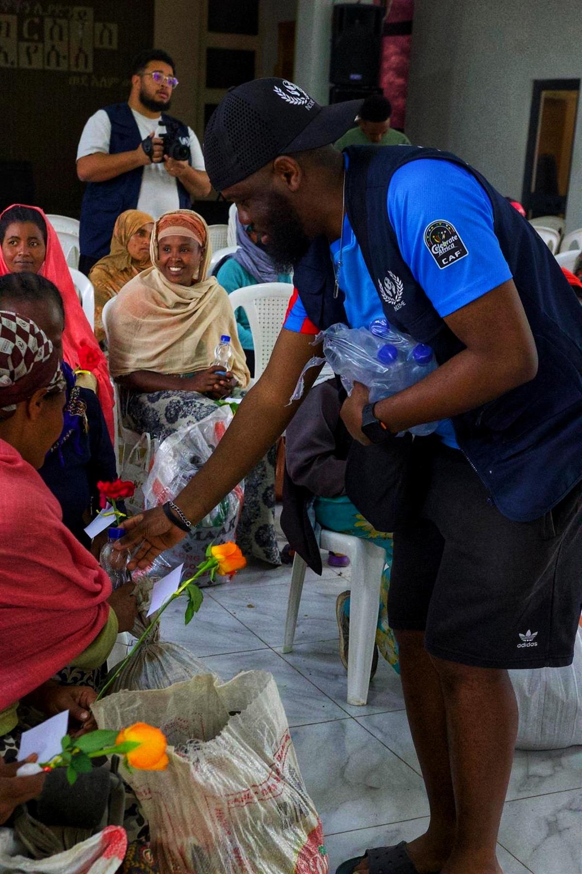 BeLight volunteer distributing aid with care